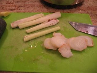 prepare lower portions of 3 stalks of lemongrass, and slices of galangal root