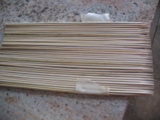 flatten a bunch of bamboo skewers. Line up their points. Tape them from the top first, then flip over. This can now be used to wrap around a core of a few skewers wrapped with a buffer of paper towels